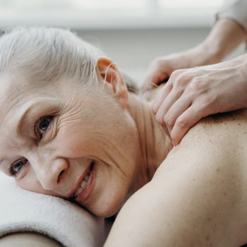 Une femme âgée se faisant masser le dos